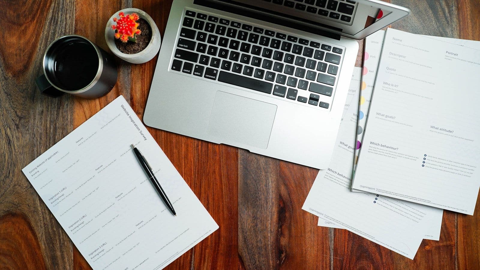 A laptop computer sitting on top of a wooden desk, illustrating how to Get a Free Credit Report.