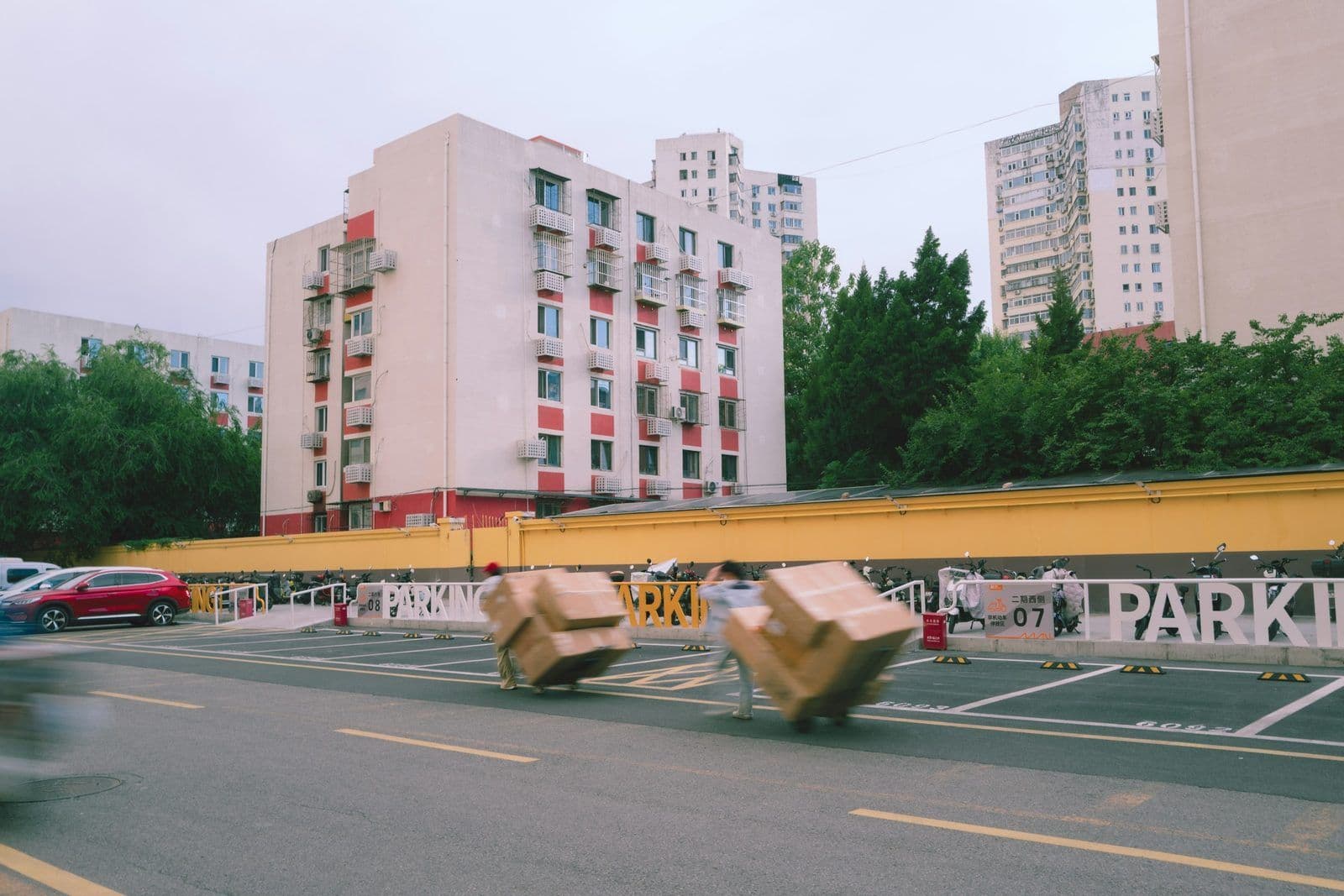 Moving boxes outside an apartment building, illustrating the credit impact of breaking a lease.