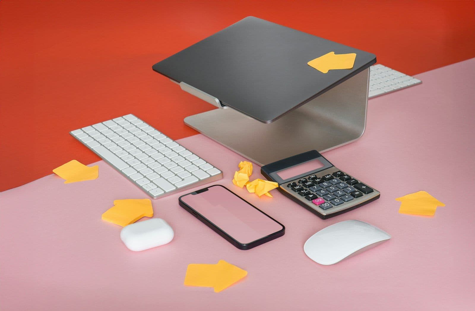 A cell phone, keyboard, mouse, and mouse pad on a pink surface, illustrating 1 in 5 Credit Reports Have Errors.