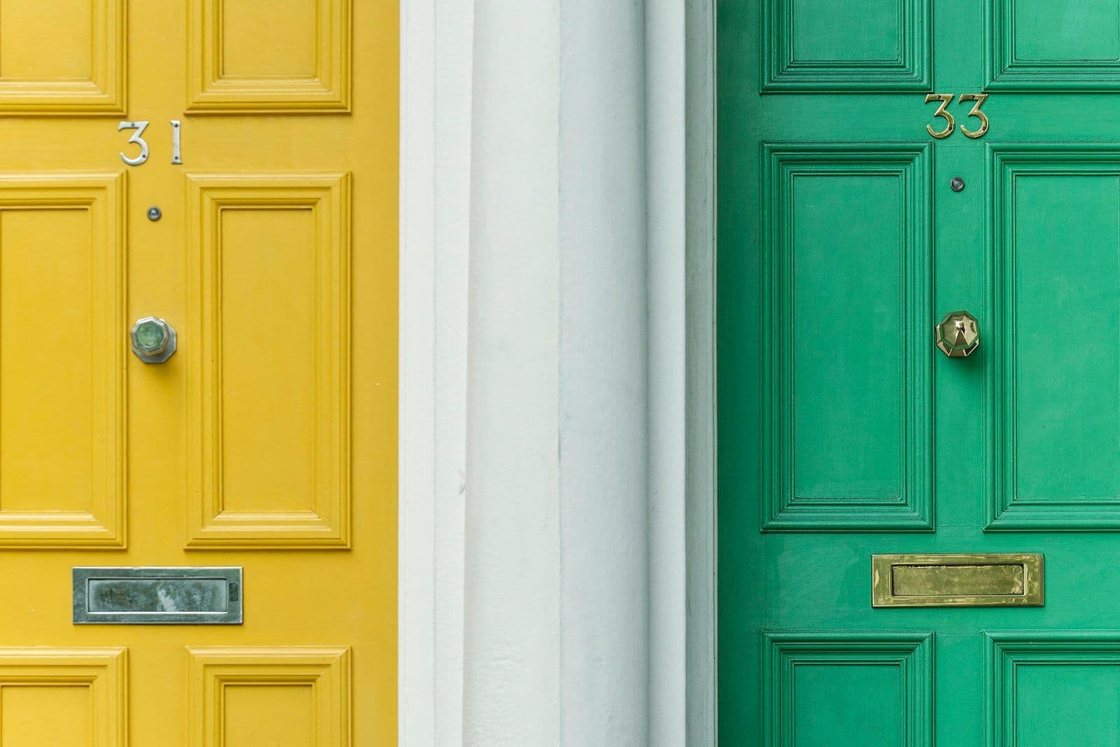 Two different colored doors side by side, illustrating the choice between credit repair and credit counseling.