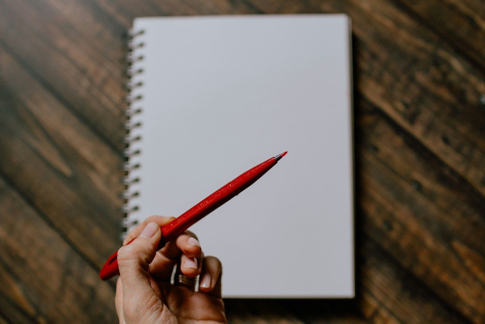 Red pen marking a document, illustrating derogatory marks on a credit report.