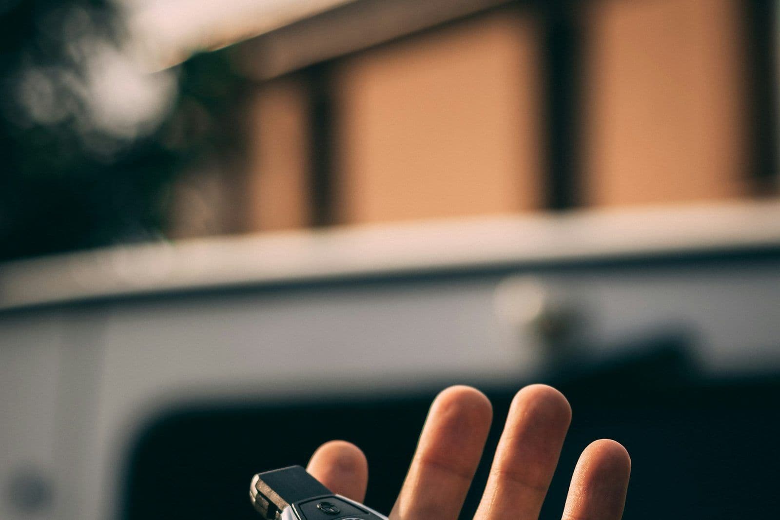 Car keys being handed over, illustrating whether leasing a car builds credit.