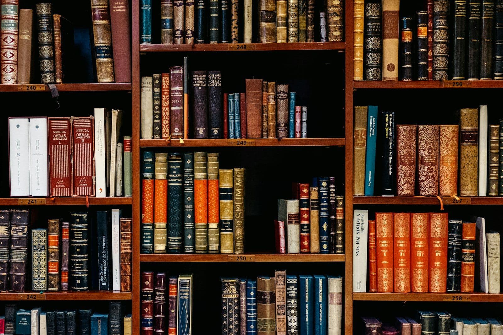 Assorted-title of books piled in the shelves, illustrating employer Credit Checks Under FCRA Section 604.