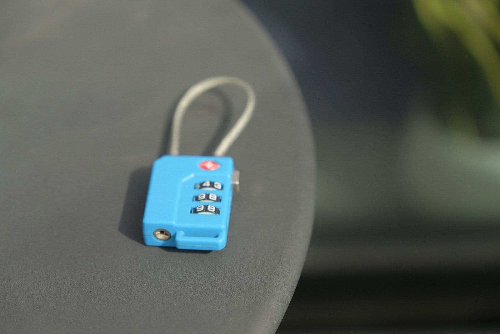 A small blue combination lock rests on a surface, illustrating identity Theft and Credit Reports.