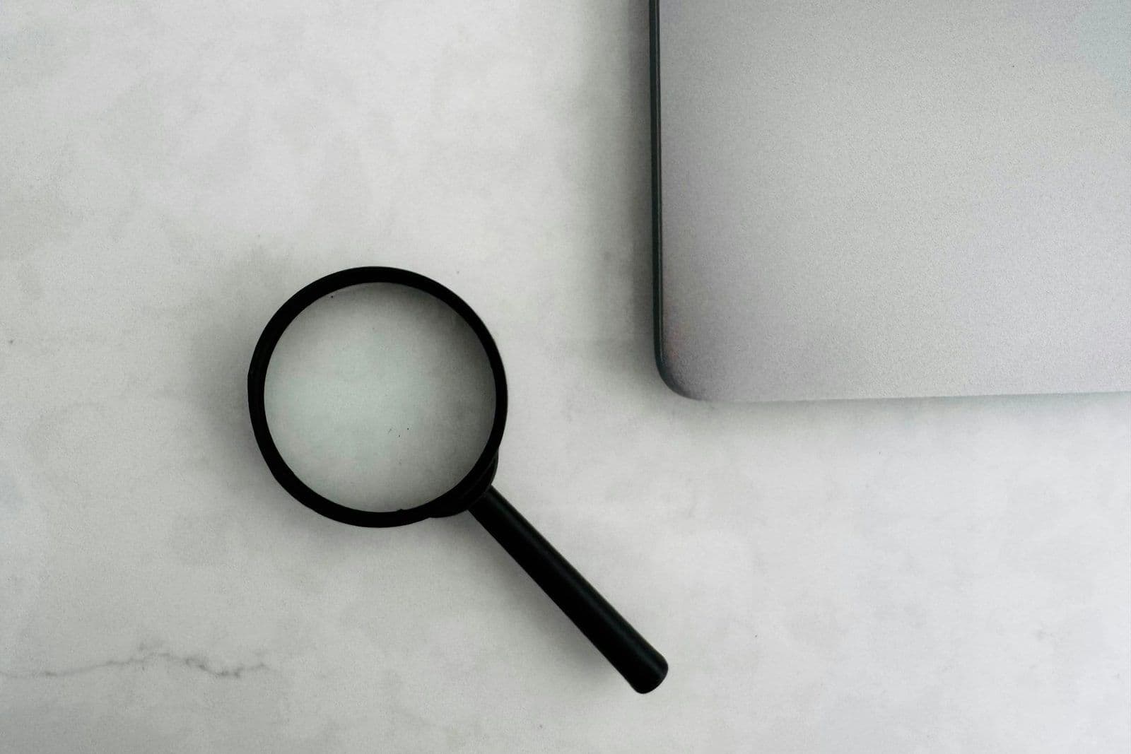 A magnifying glass over a map, illustrating how debt collectors locate consumers.