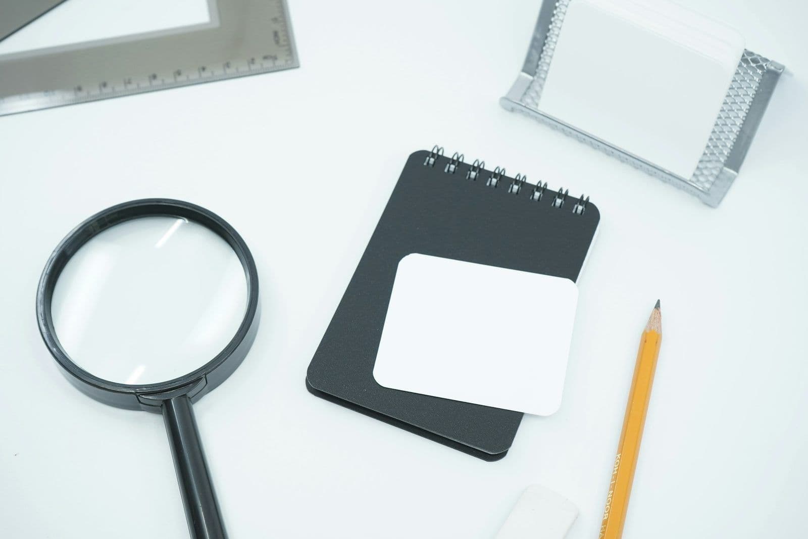 A checklist beside a magnifying glass, illustrating how to evaluate credit repair companies.