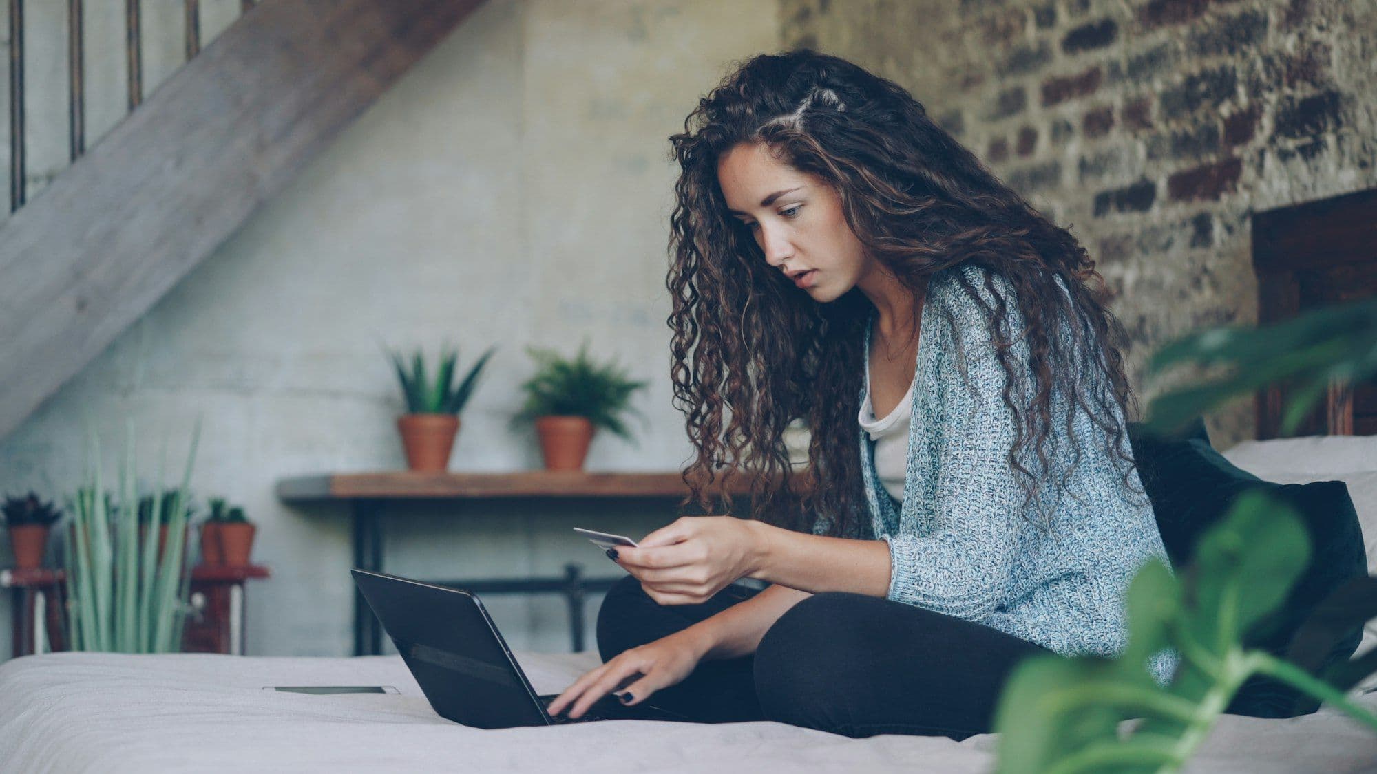 Woman making an online payment with a credit card and laptop