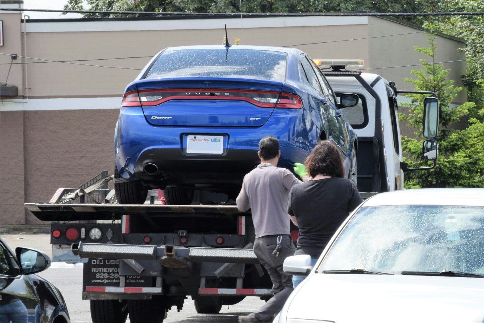 A car being towed, illustrating deficiency balances after repossession.
