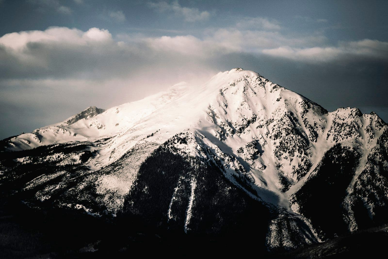 A mountain summit above the clouds, illustrating reaching the highest credit score.