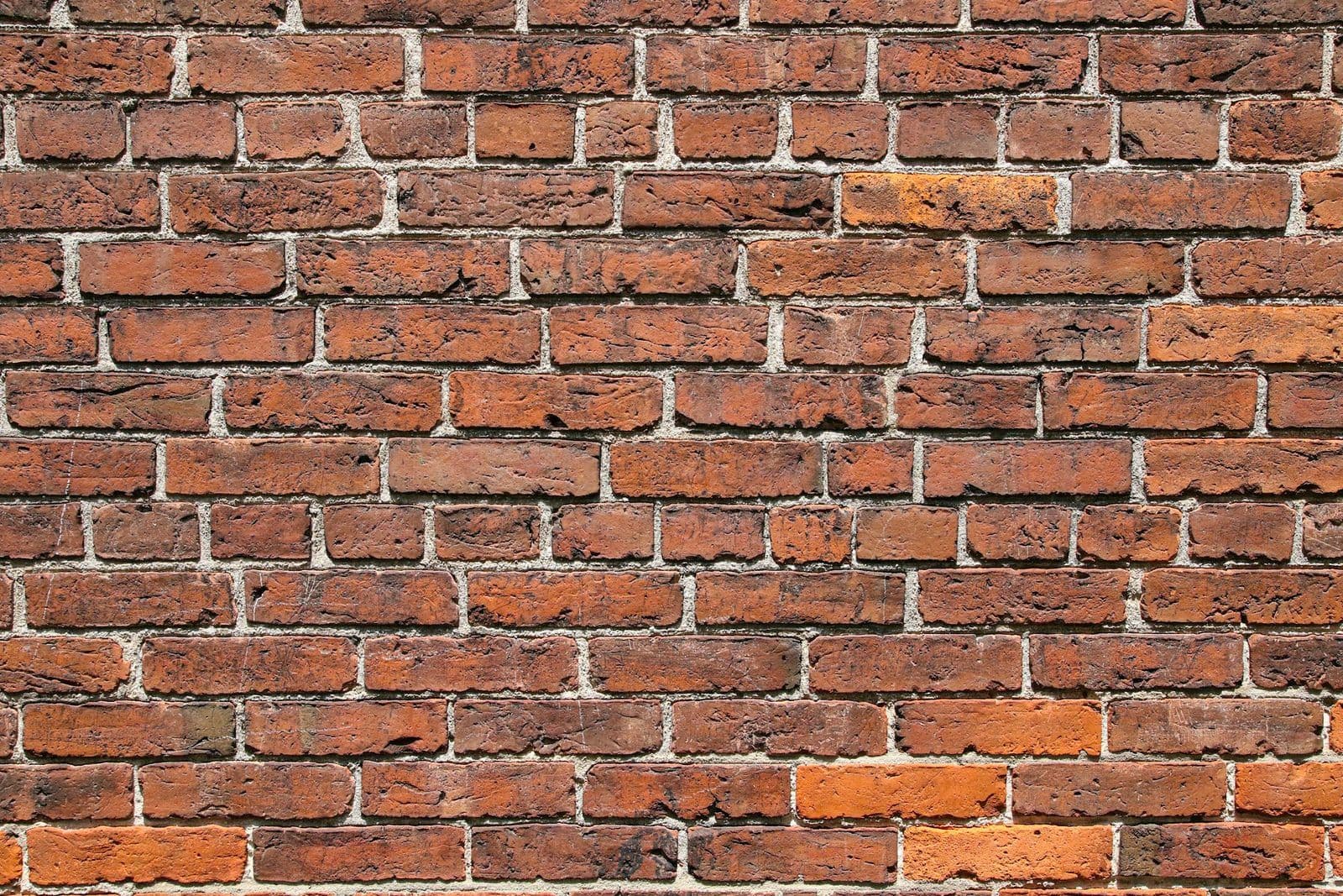 Bricks being stacked into a wall, illustrating the process of rebuilding damaged credit.