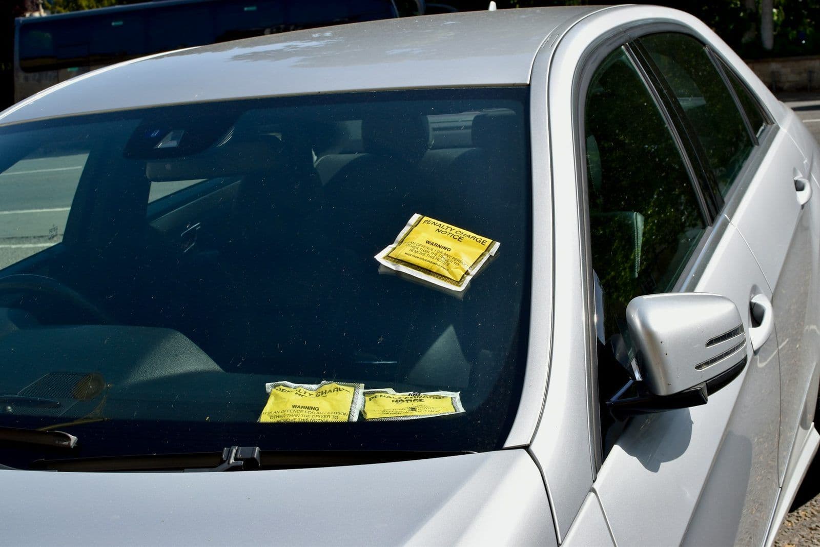 A parking ticket under a windshield wiper, illustrating whether tickets affect credit.