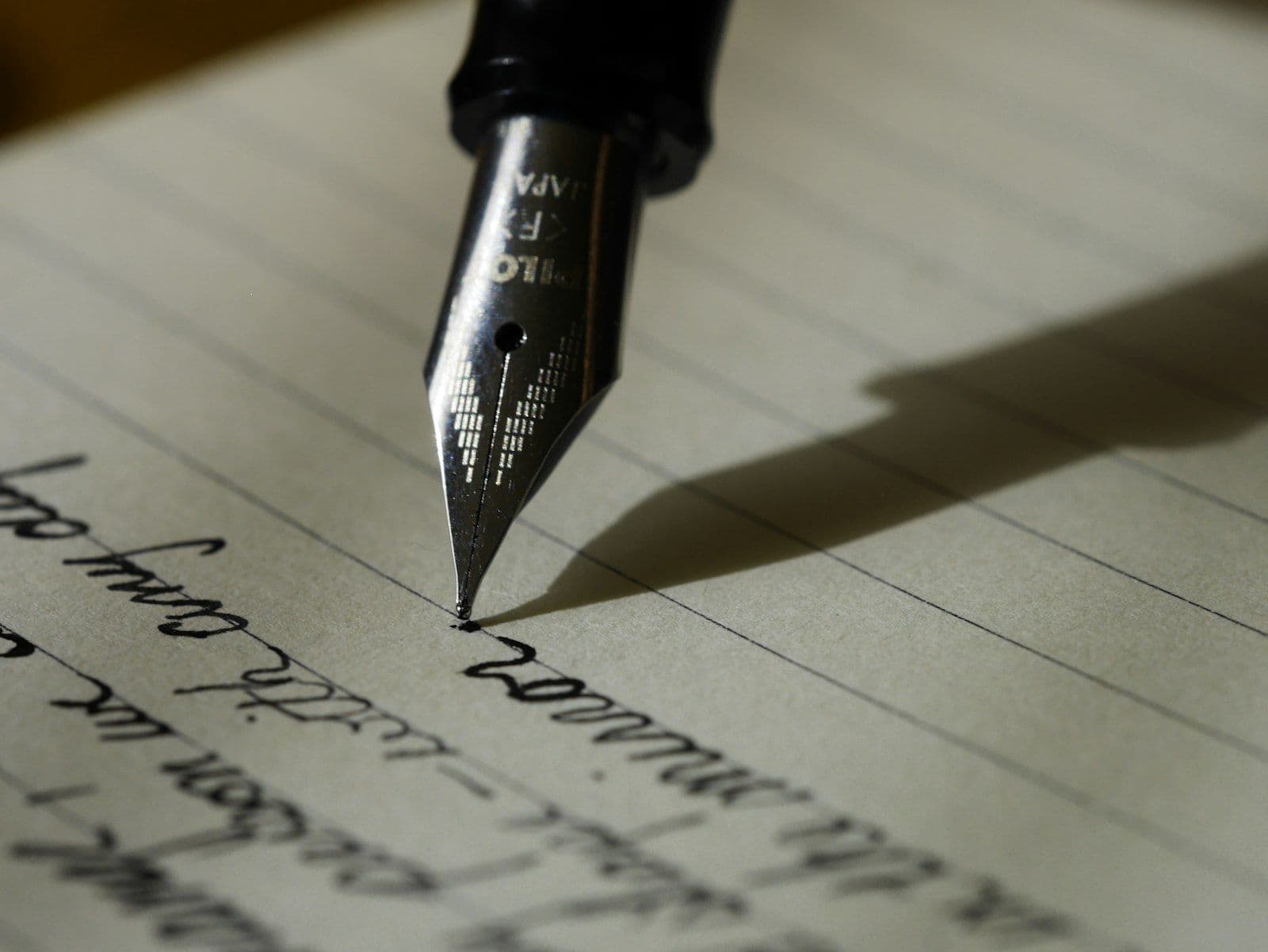 Writing with a fountain pen, illustrating filing a consumer statement of dispute on a credit report.