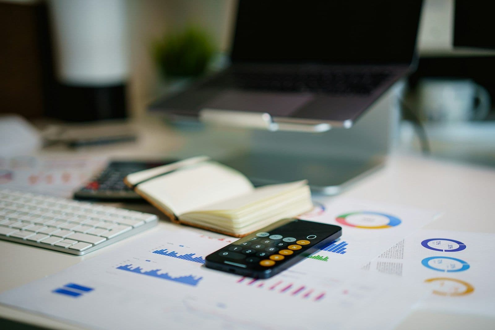 Payroll documents and a calculator on a desk, illustrating The Work Number employment data report.