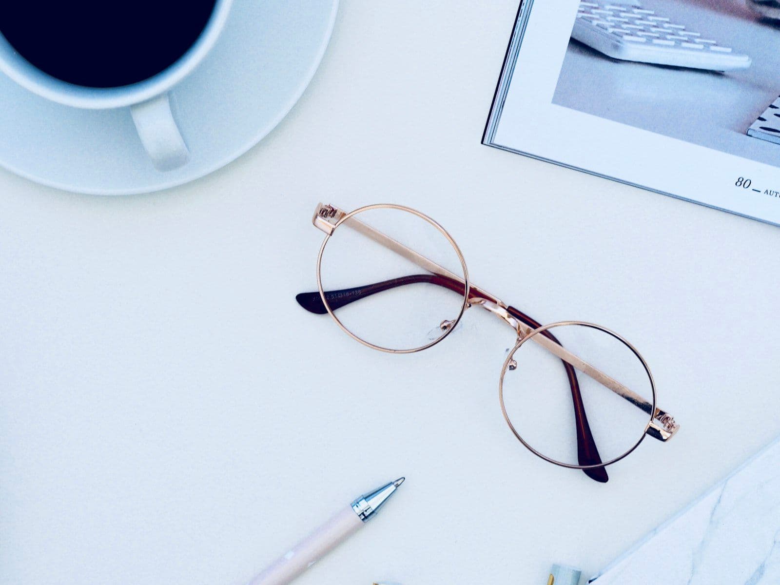 Reading glasses resting on financial documents, illustrating a section-by-section read of a credit report.