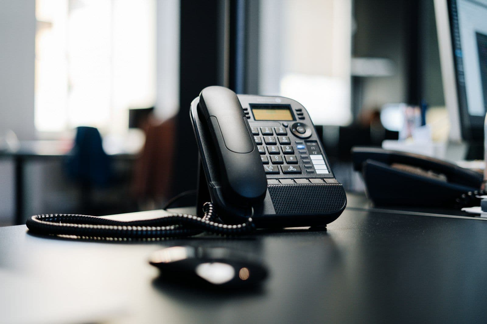 Telephone on an office desk, illustrating FDCPA rules on debt collector calls at work.
