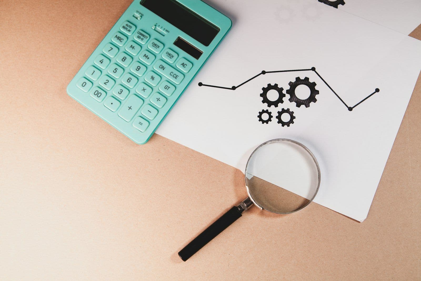 Magnifying glass resting on financial documents, illustrating the difference between soft and hard credit inquiries.