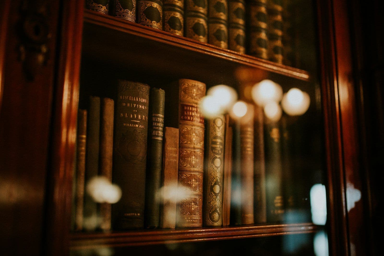 Books in glass bookcase, illustrating what Is a Tradeline on a Credit Report.