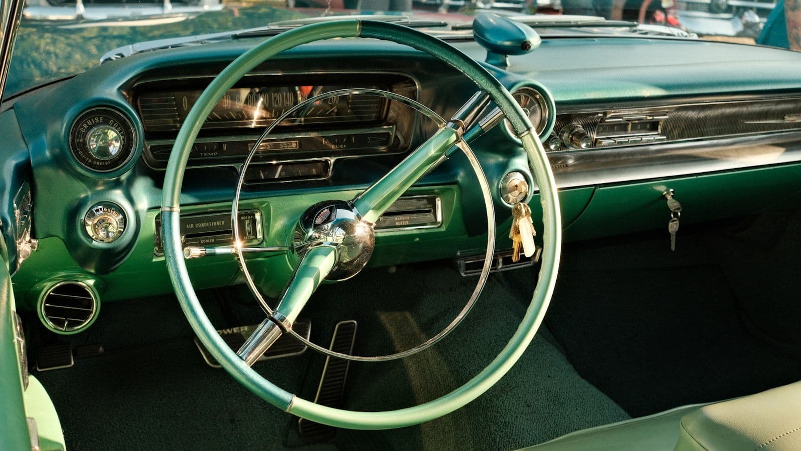 A green car with a steering wheel and dashboard, illustrating secured Credit Cards.