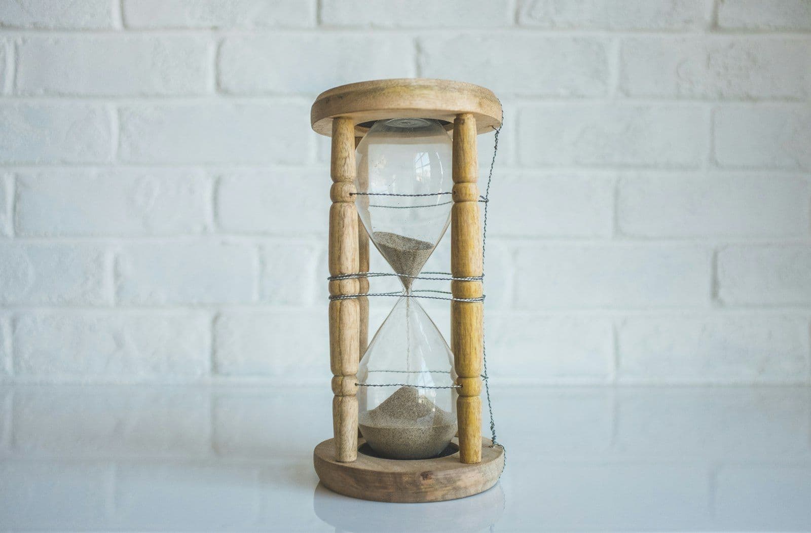 Hourglass on a desk, illustrating how long negative information stays on a credit report.
