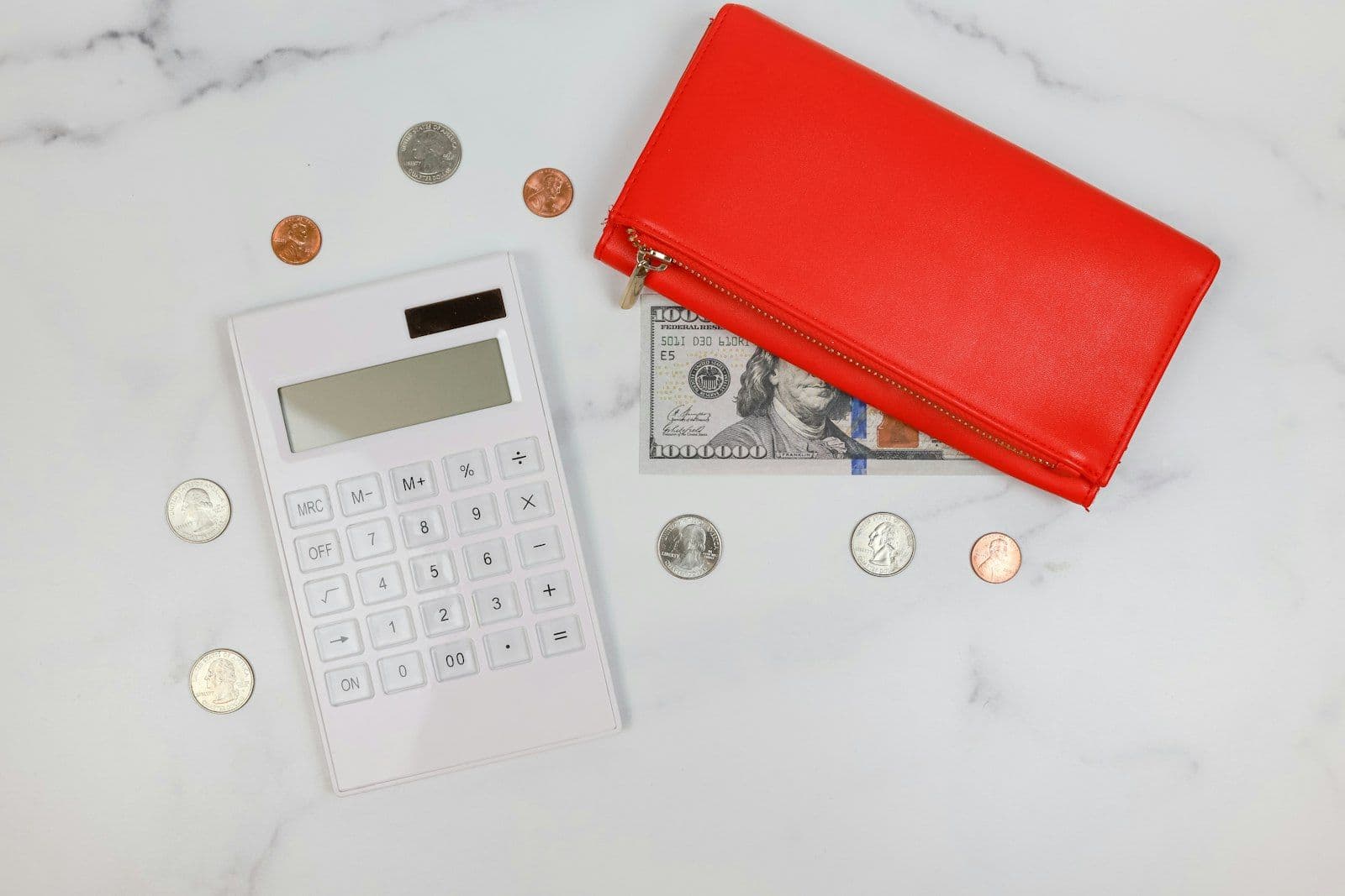 Calculator on a stack of bills, illustrating the audit of fees and interest a debt collector adds.
