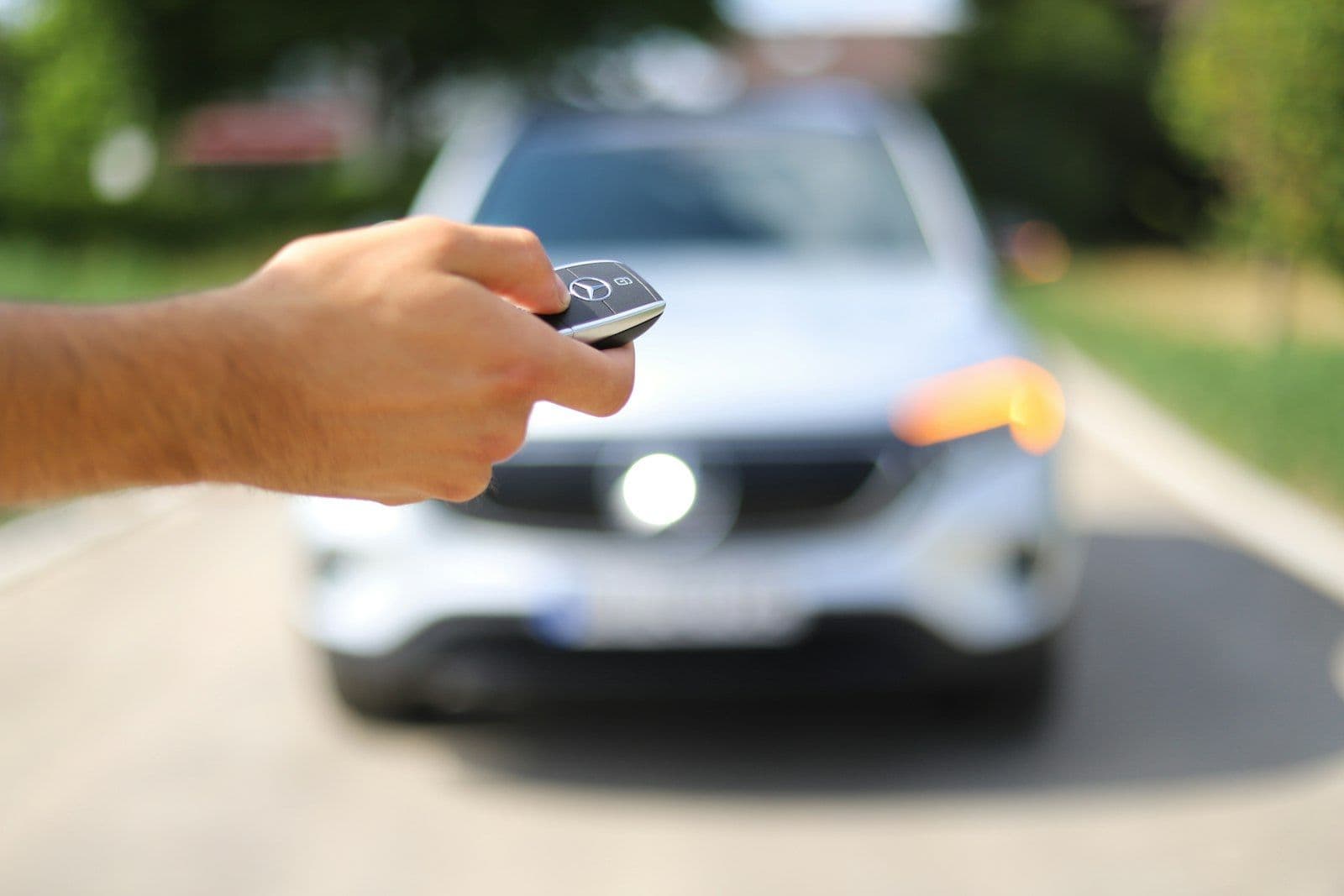 Hand holding car keys, representing voluntary repossession of a financed vehicle.