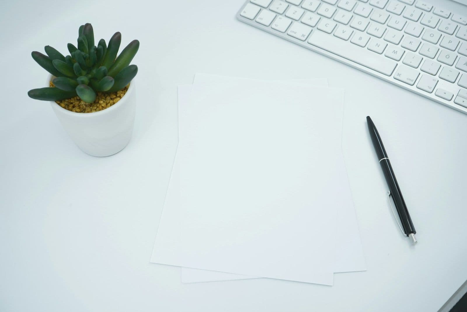 A person writing a letter by hand at a desk, illustrating how to write a credit dispute letter.