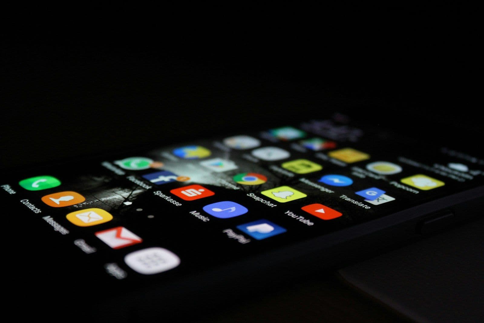 Person checking a smartphone, illustrating why credit scores differ between apps.