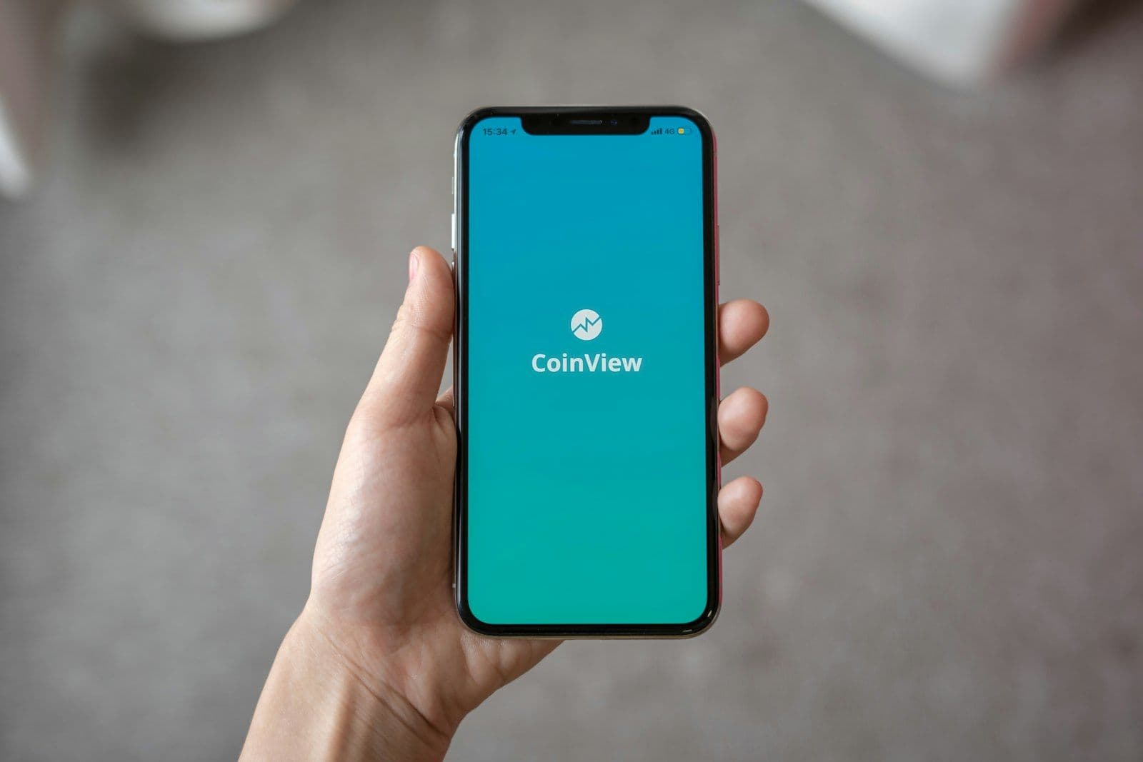 Person holding space gray iPhone X, illustrating credit Repair in One Tap.