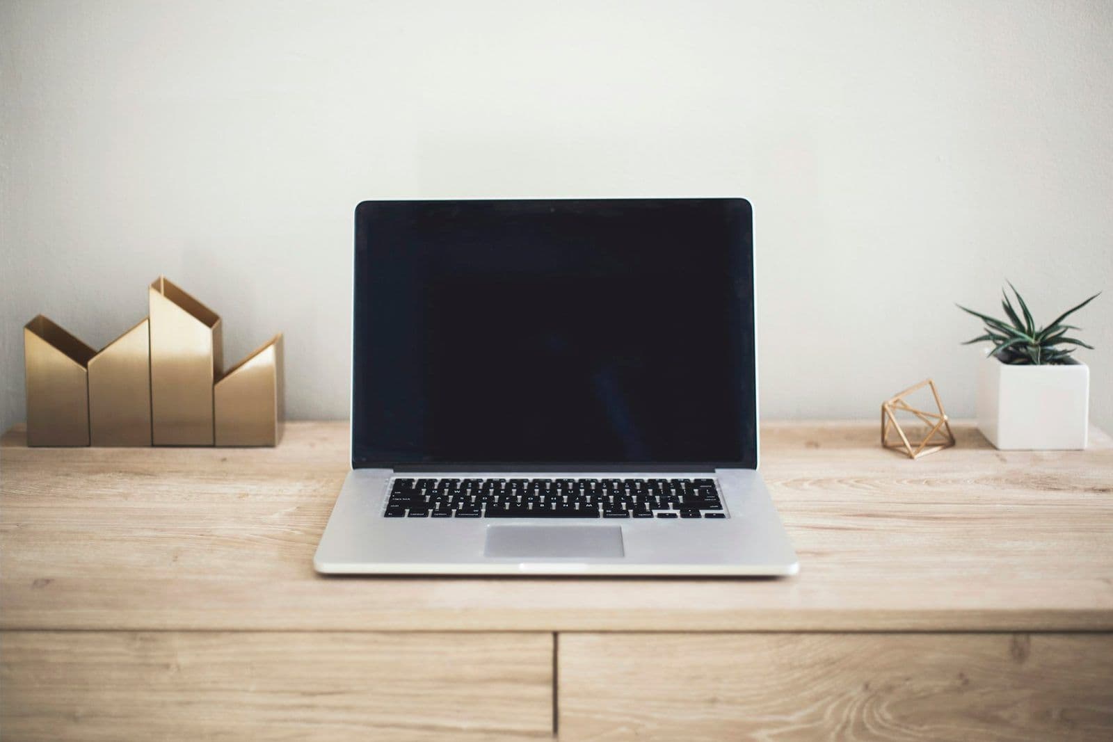 A laptop open on a desk, illustrating online credit repair compared with local companies.