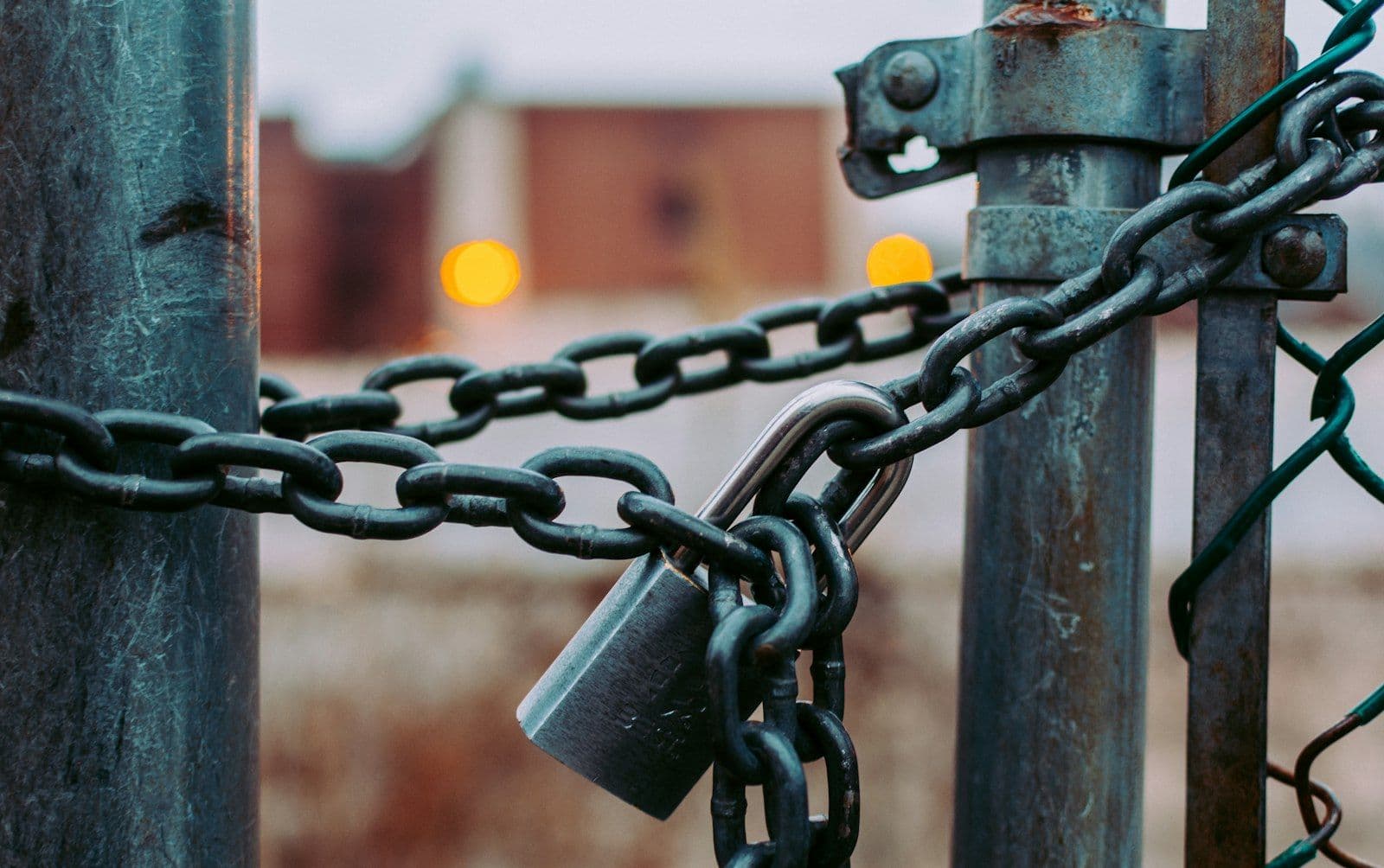 Padlock and chain on a gate, illustrating collateral and the difference between secured and unsecured debt.