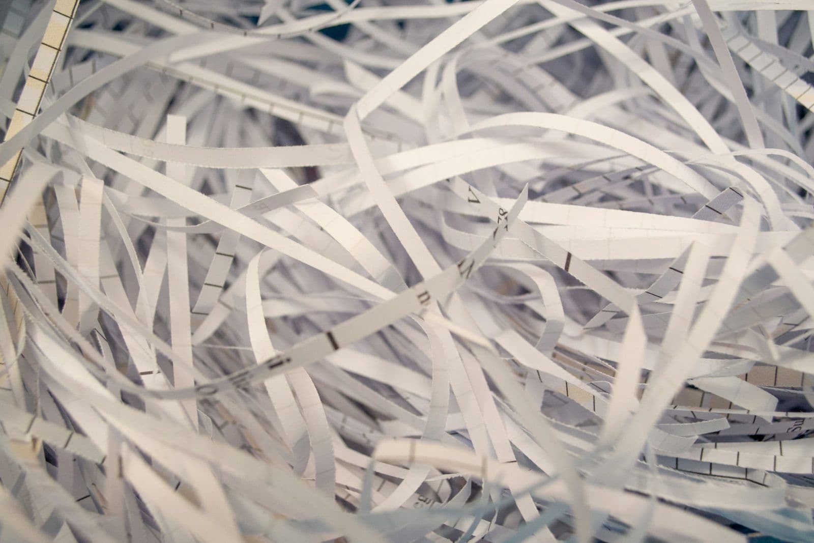 Shredded paper documents in a pile, illustrating removing collection accounts without payment.