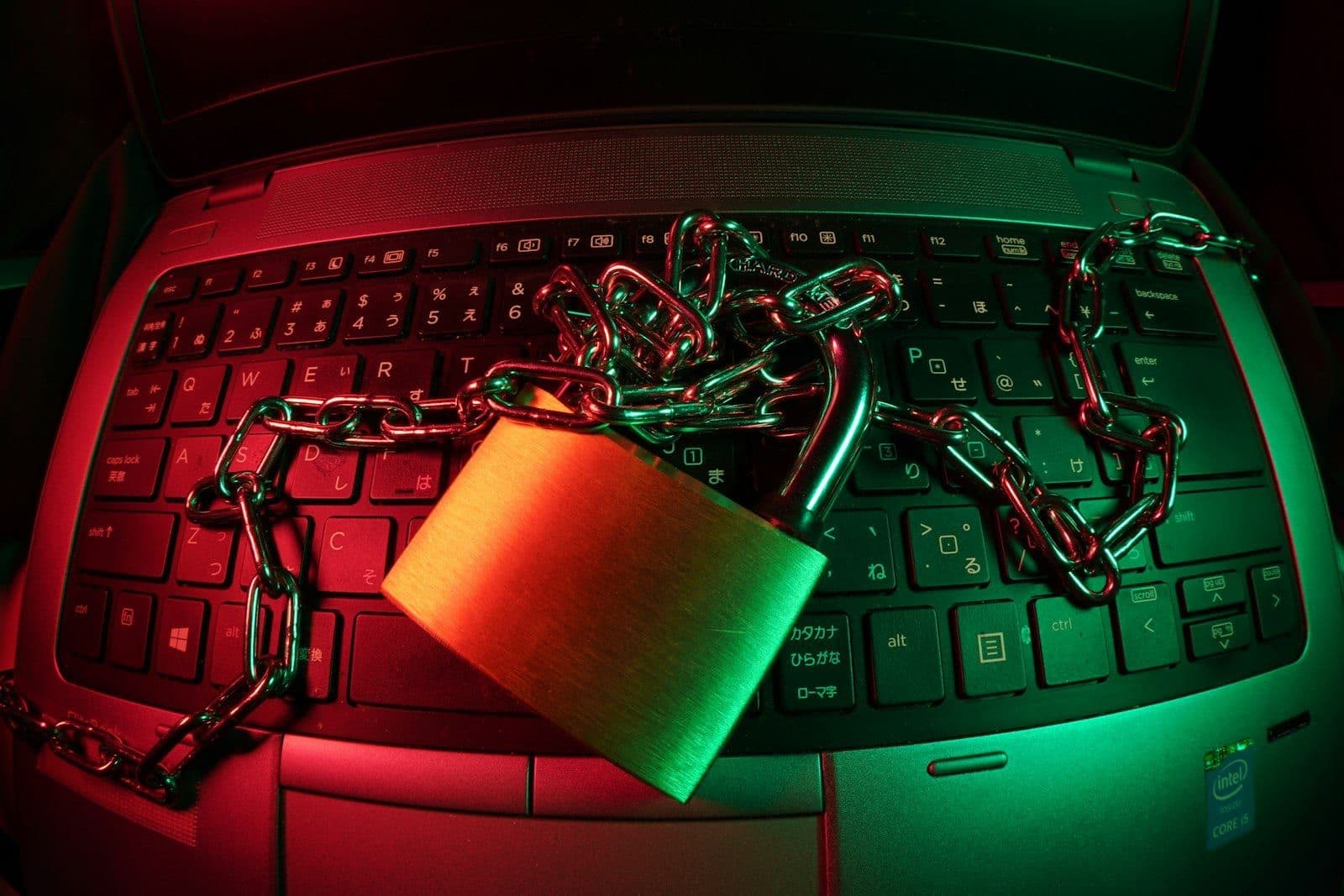 A padlock resting on a laptop keyboard, illustrating who can legally access a credit report.