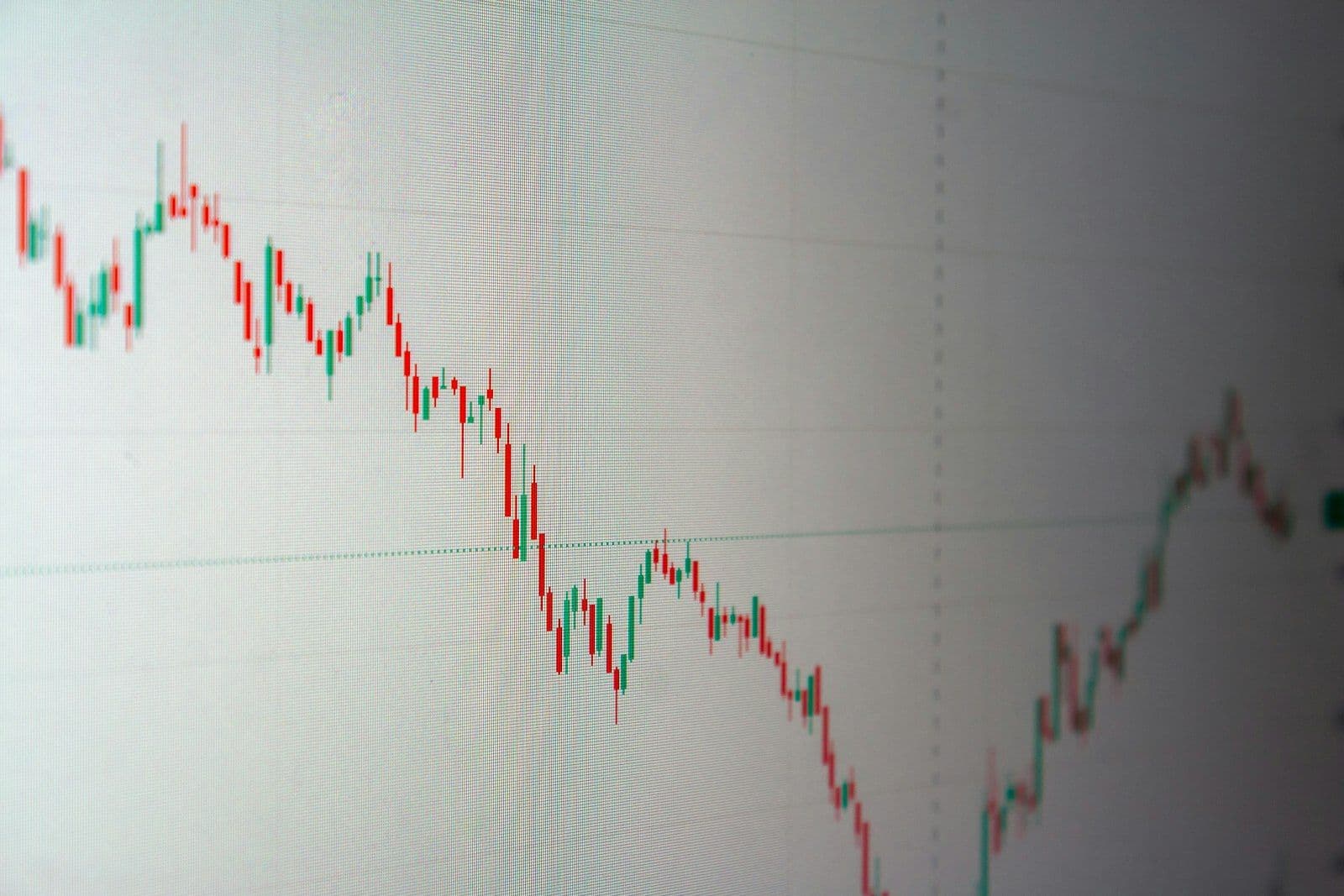 Stock market chart trending downward, illustrating a credit score drop after paying off a loan.
