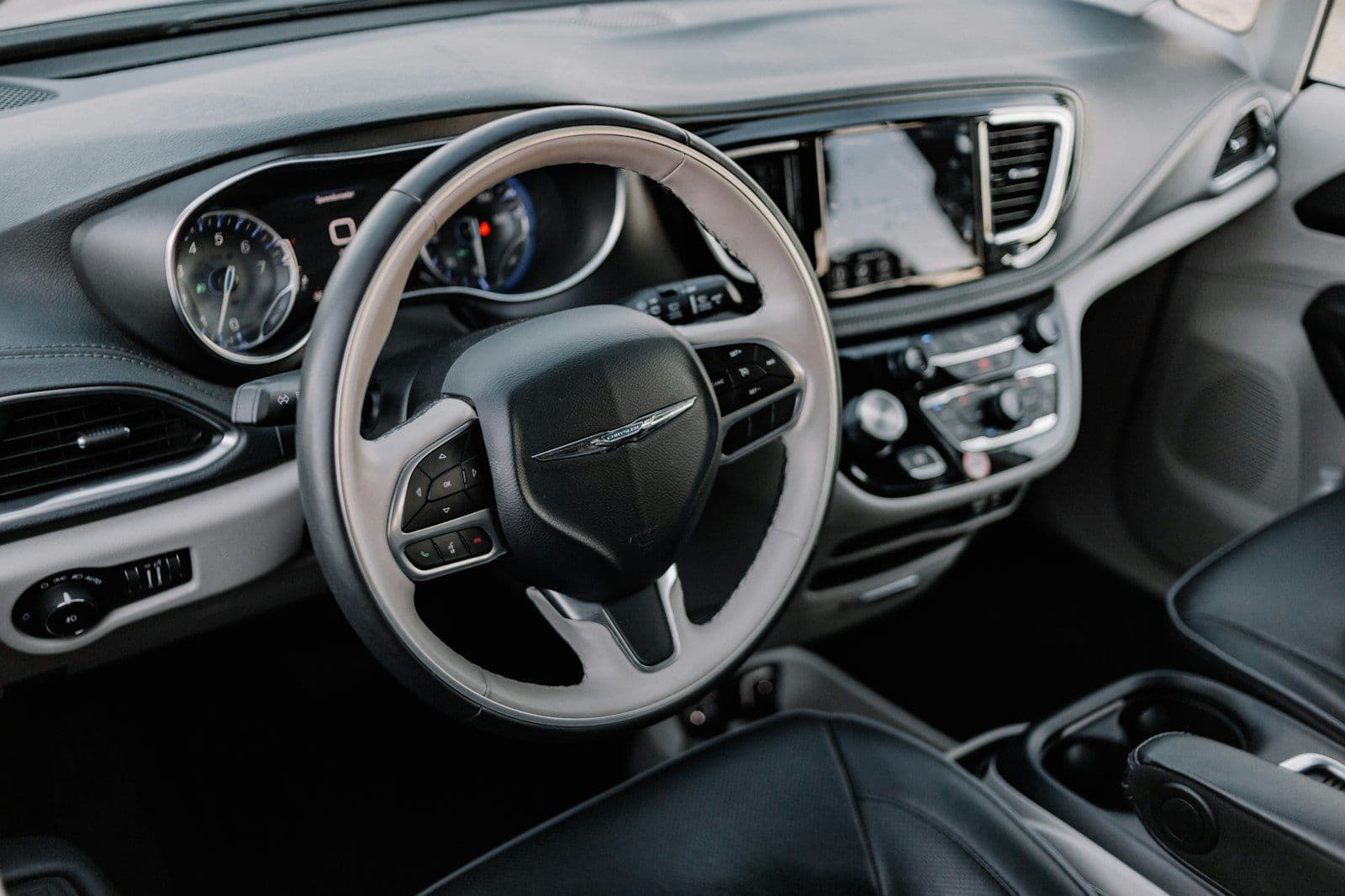 The interior of a car with a steering wheel and dashboard, illustrating does Closing a Credit Card Hurt Credit.