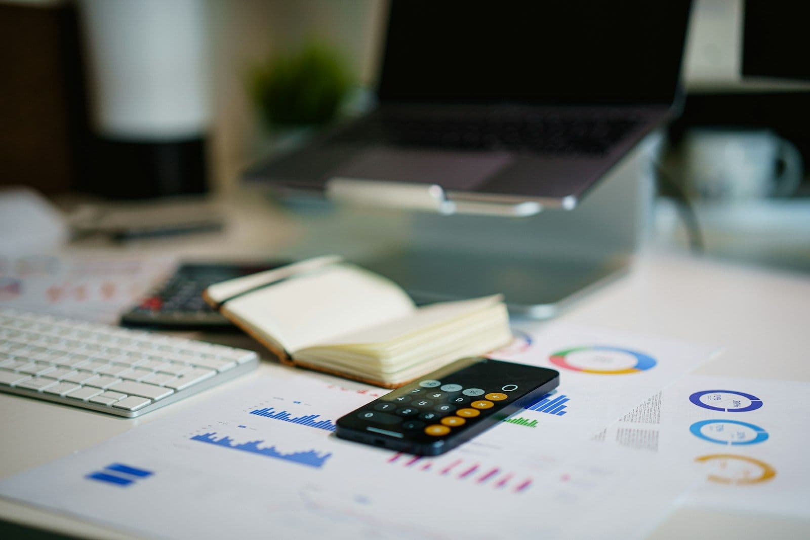 Calculator and notebook for budgeting, illustrating how a debt management plan works.