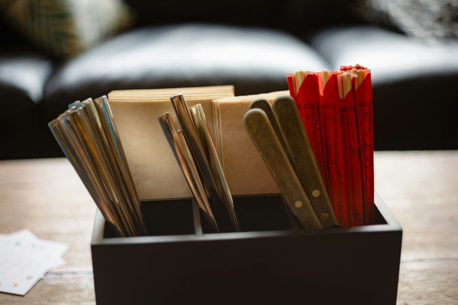 Utensils and fortune sticks in a holder, illustrating how to Remove a Collection From a Credit Report.