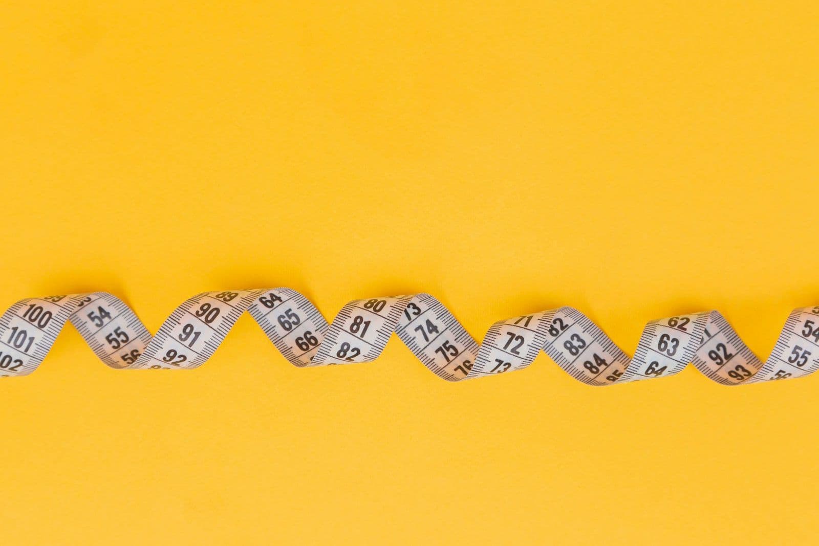 A tape measure pulled out a short length, illustrating a credit limit decrease.