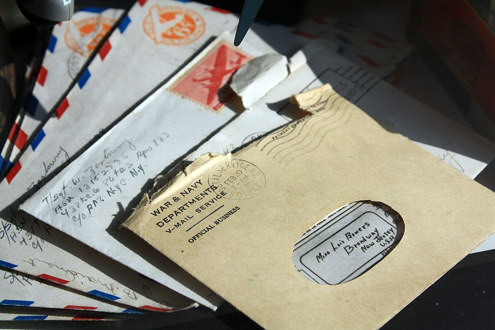 Pile of unopened envelopes, illustrating the cost of ignoring debt collection notices.