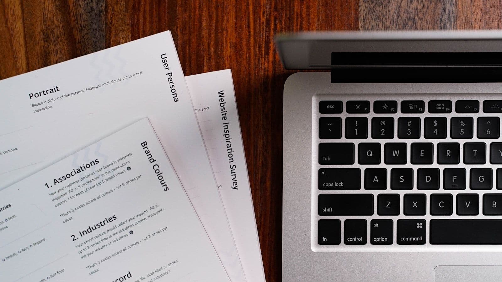 A laptop computer sitting on top of a wooden table, illustrating how to Read a Credit Report.