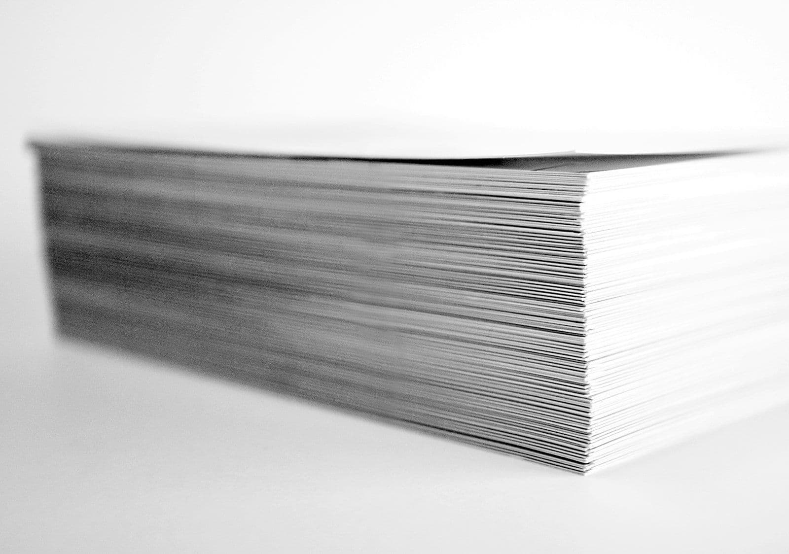 Stack of papers, illustrating how to Negotiate With Debt Collectors.