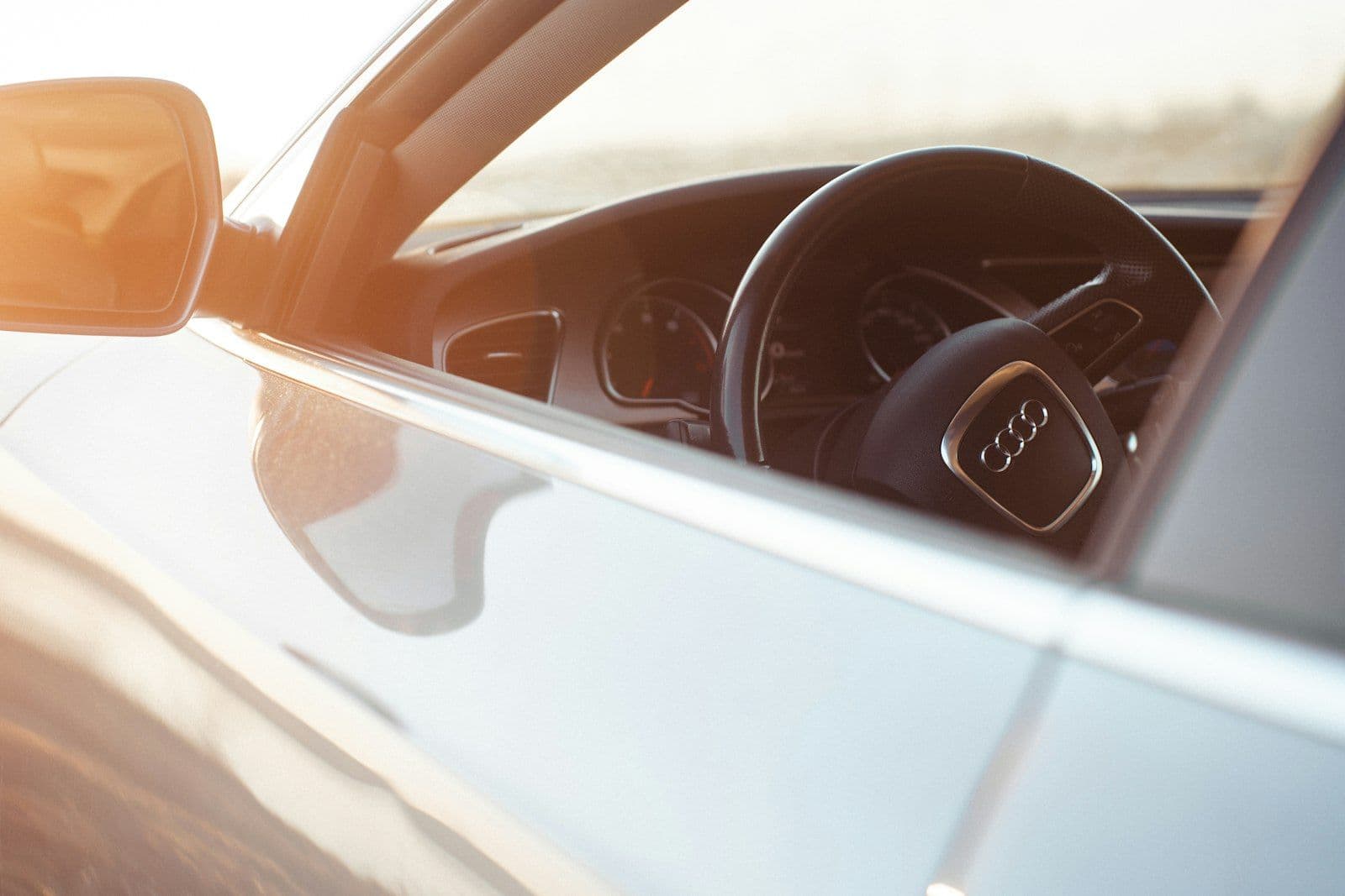 A close up of a car's steering wheel and dashboard, illustrating how to Close a Credit Card Without Hurting a Credit Score.