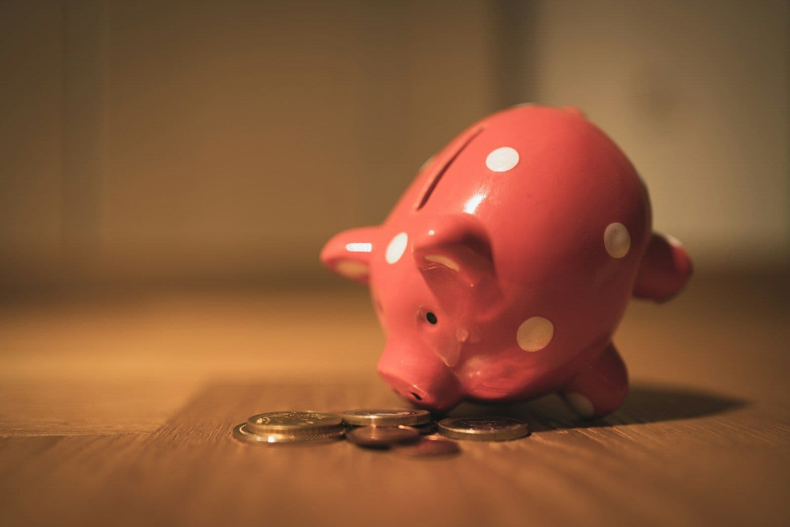 Child adding a coin to a piggy bank, illustrating freezing a child's credit for protection.