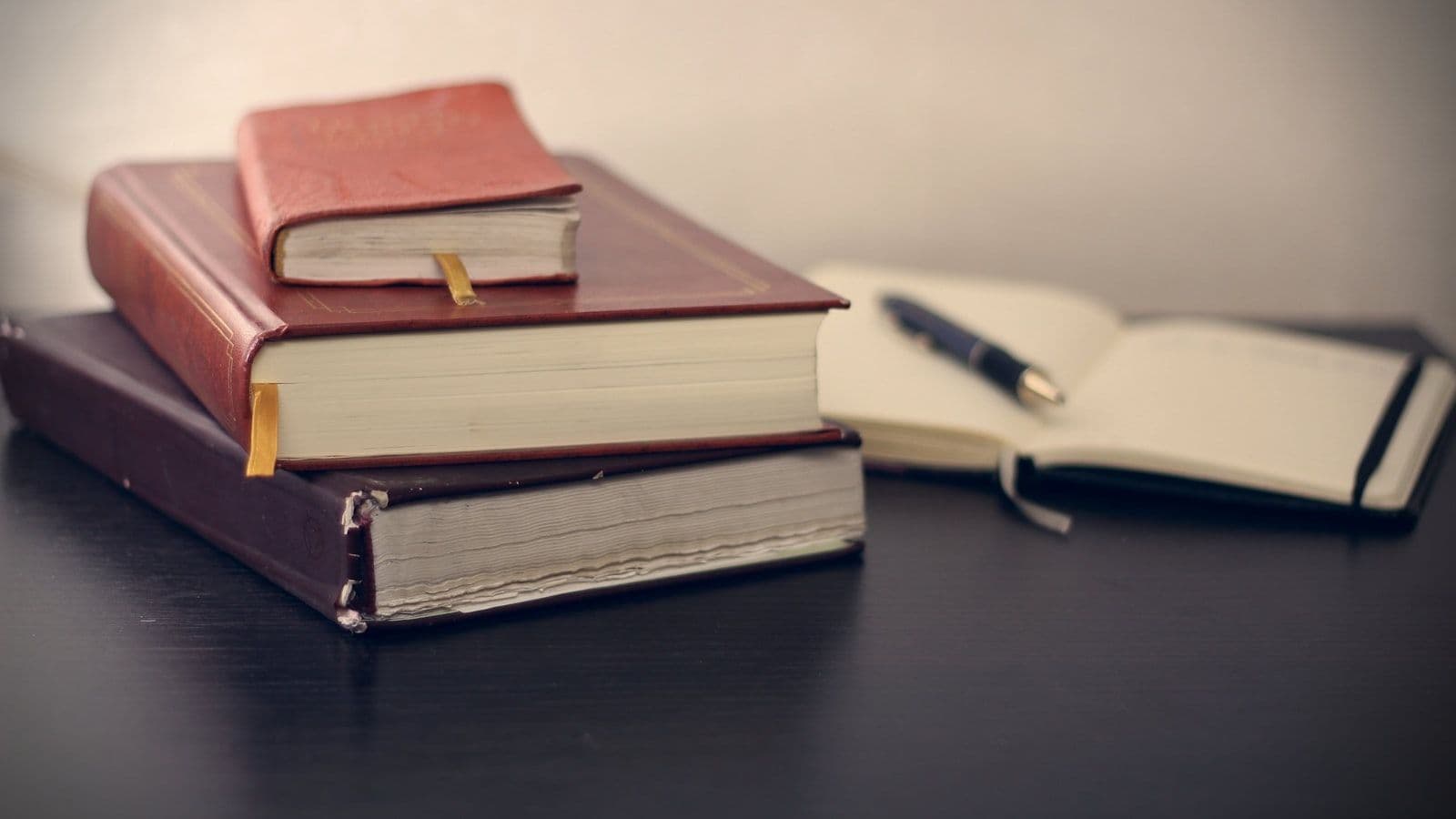 Selective focus photography of three books beside opened notebook, illustrating credit Discrimination Rights Under ECOA.