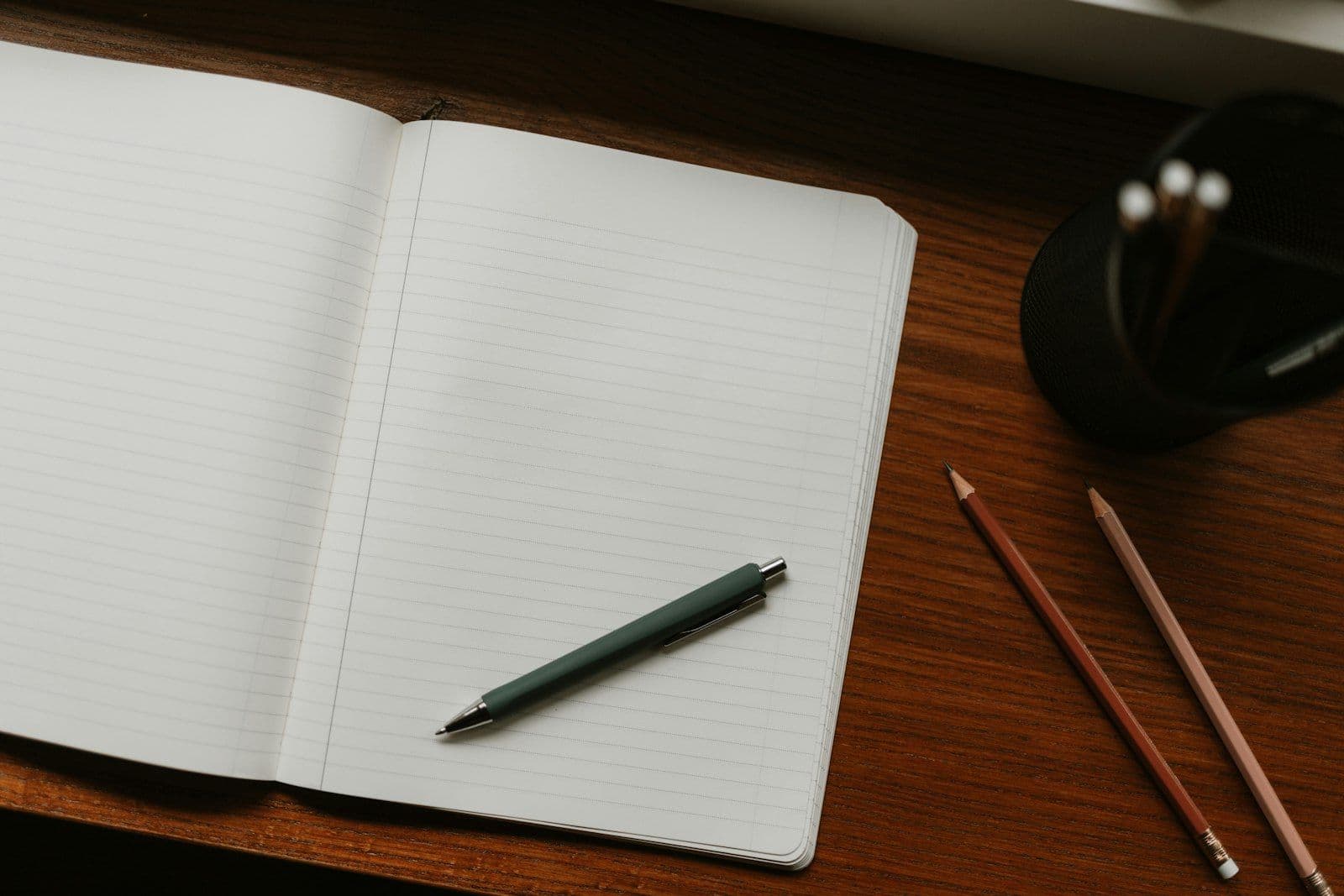 Open notebook with pen and pencils on desk, illustrating frivolous Dispute Classifications Under FCRA.