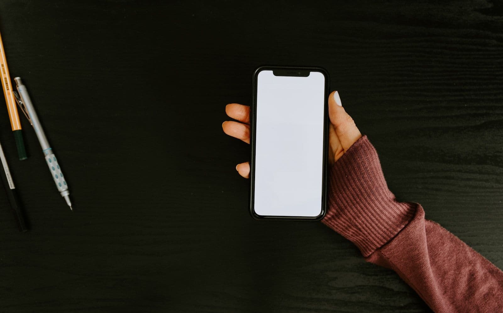 Person holding white iphone 5 c, illustrating how AI Finds Every Error on a Real Credit Report in 47 Seconds.
