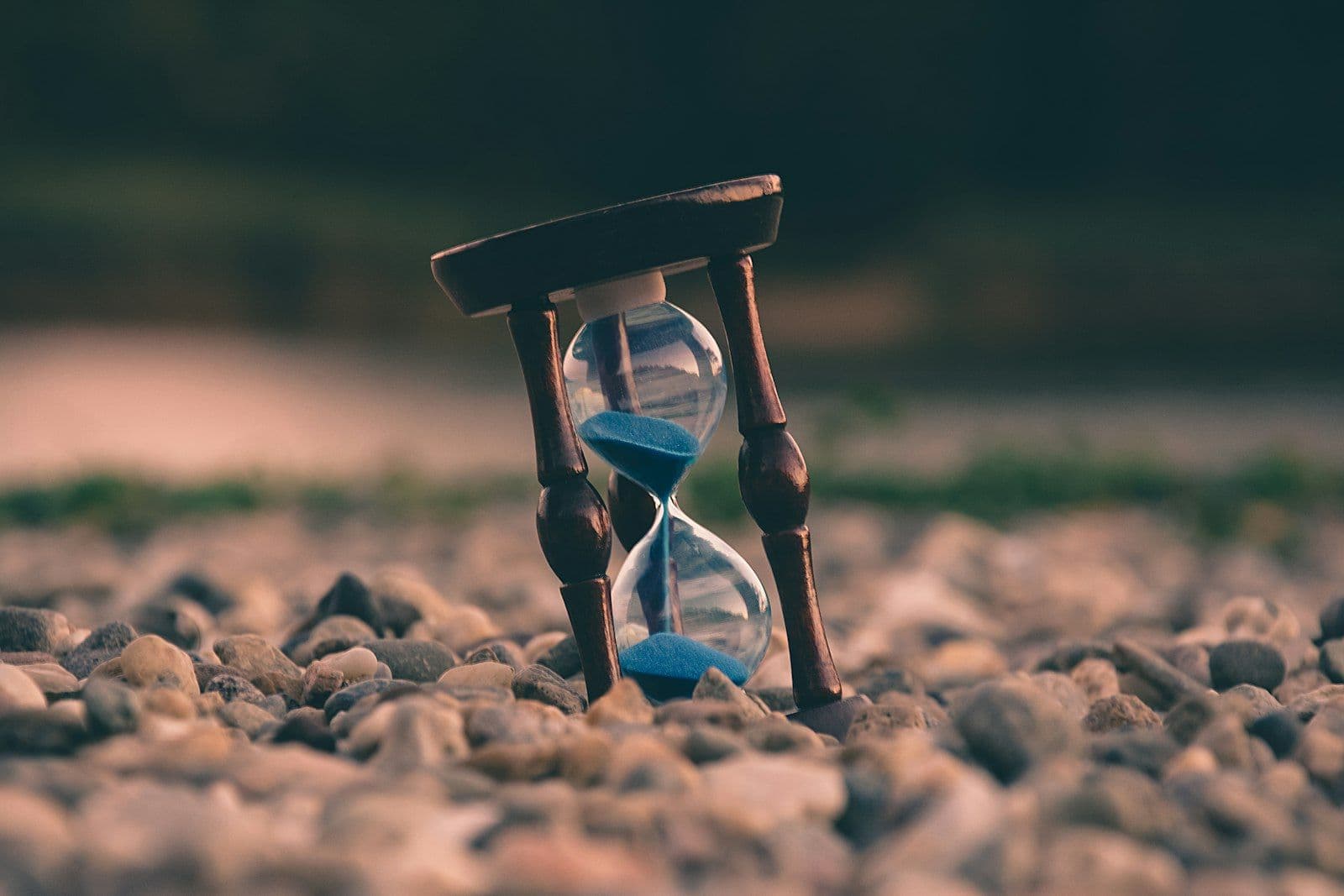 Hourglass with sand running, illustrating the decades-long payoff timeline of minimum credit card payments.