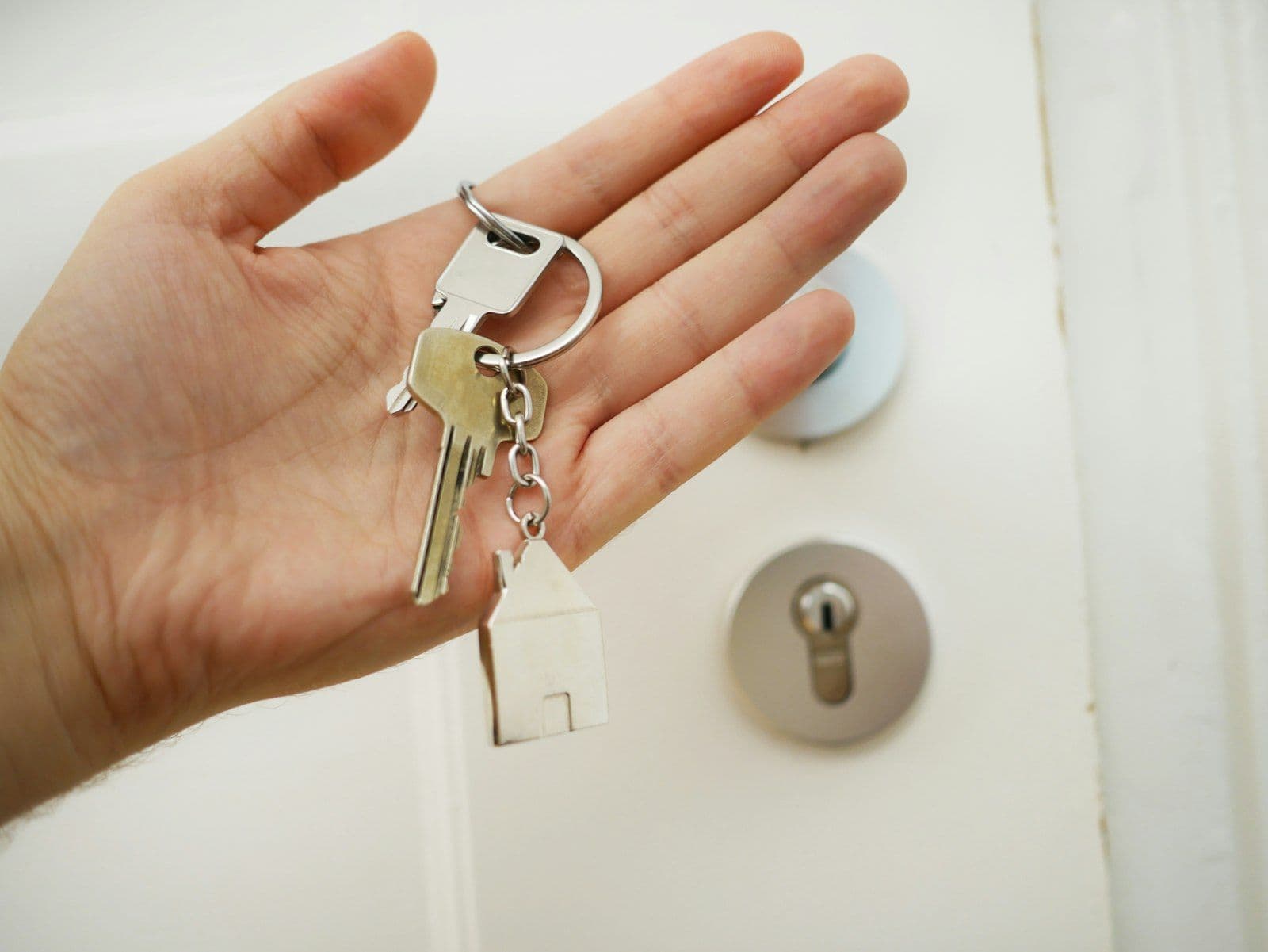 House keys changing hands, illustrating mortgage preapproval versus prequalification.