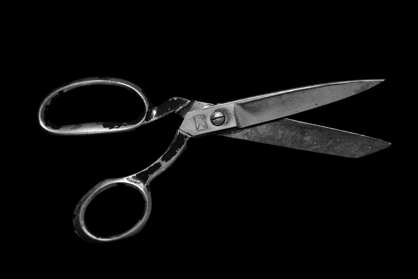 Scissors cutting paper, illustrating removing Enhanced Recovery Company from a credit report.